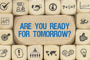 Würfel mit Schriftzug "Are you ready for tomorrow?" umgeben von anderen Würfeln mit unternehmerischen Icons.